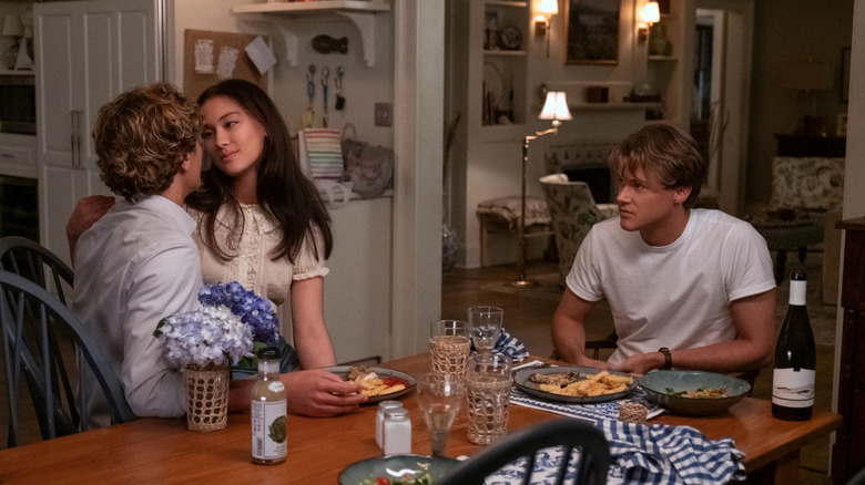 Jeremiah and Belly canoodling at the kitchen table and Conrad watching on The Summer I Turned Pretty
