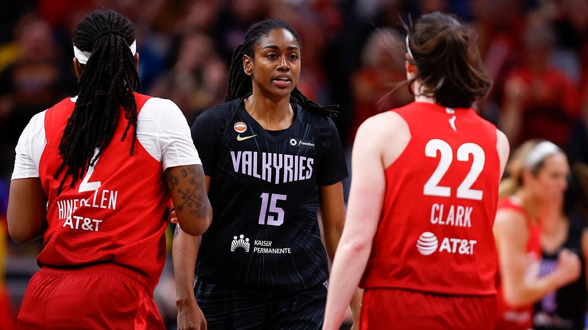 Tiffany Hayes and Caitlin Clark talking on basketball court during WNBA game