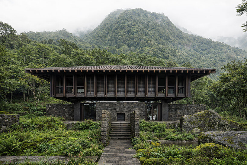 V taller proposes forest retreat around monolithic stone core for NOT A HOTEL in japan - 3