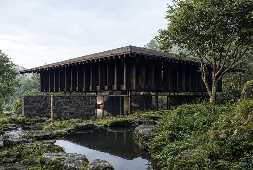 V taller proposes forest retreat around monolithic stone core for NOT A HOTEL in japan - 1