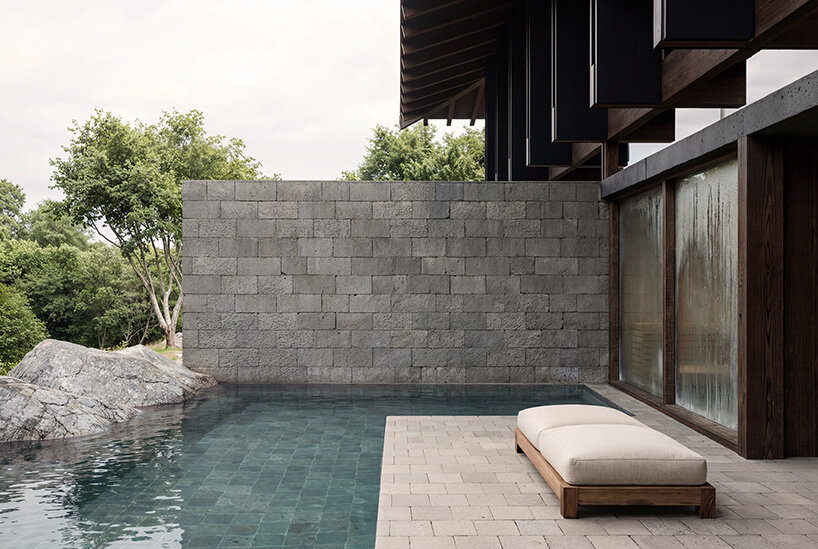V taller proposes forest retreat around monolithic stone core for NOT A HOTEL in japan - 5