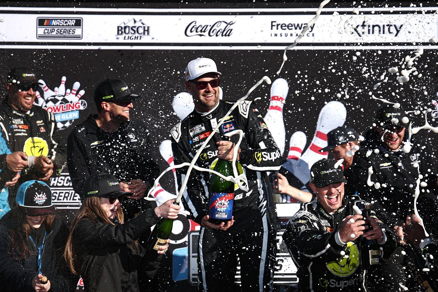 Shane Van Gisbergen, driver of the #97 Superfile Chevrolet, and crew spray champagne in victory lane after winning the NASCAR Cup Series Go Bowling at The Glen at Watkins Glen International on May 10, 2026 in Watkins Glen, New York. (Photo by Chris Graythen/Getty Images)
