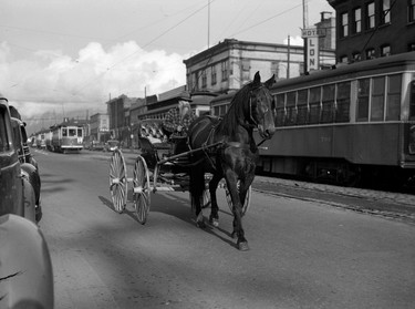 1940: Horse-drawn buggy and street cars on Main Street in Vancouver.