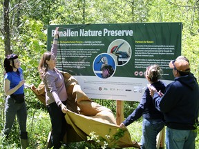 Escarpment Biosphere Conservancy CEO Beth Gilhespy unveils the new sign at the official opening of the Benallen Nature Preserve on Saturday, May 30, 2026. Greg Cowan/The Sun Times