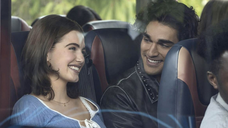 Hannah and Justin sitting next to each other on a bus in 