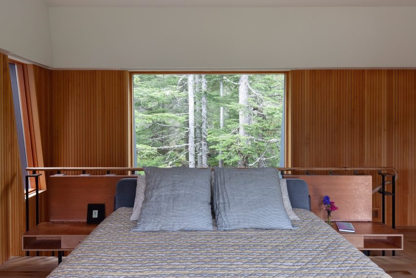 Bedroom with a window overlooking treetops