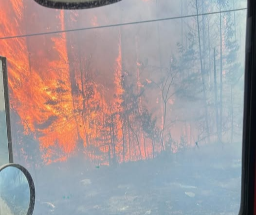 Community evacuates as wildfires burn along Hwy 11, across region