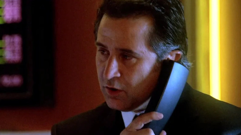 Jack Malone with phone to his ear and speaking