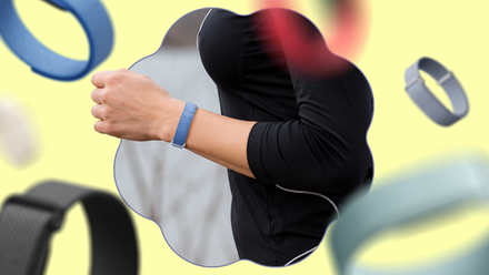 Woman wearing a blue Fitbit Air fitness band with colorful bands floating around in the background.