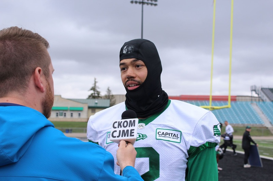 Saskatchewan Roughriders linebacker Josh Woods speaks with reporter Scott Roblin on the sidelines at Rider training camp on May 21, 2026.