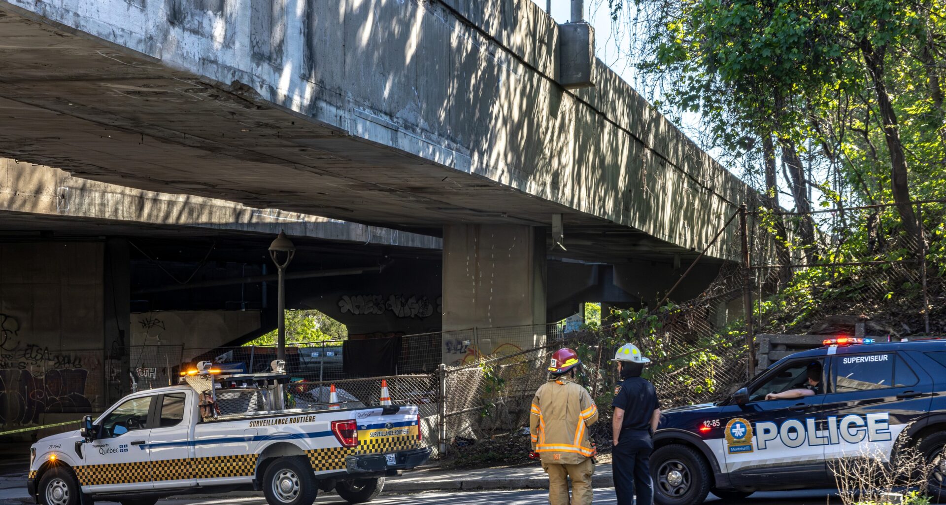 Firefighters and police respond to an incident at a viaduct.