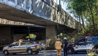 Firefighters and police respond to an incident at a viaduct.