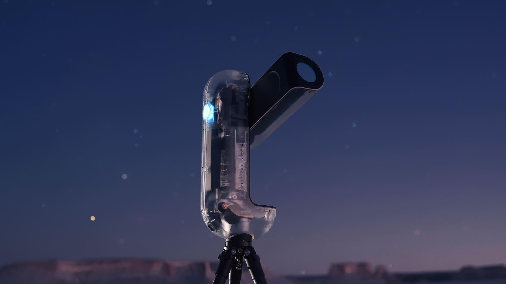 A close-up of the Vaonis Vespera II - X edition showing the clear outer shell and inner workings while pointing at the sky with a starry night sky in the background.