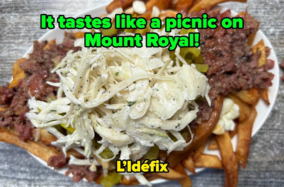 A plate of loaded fries topped with sliced beef, shredded cabbage, pickles, and a creamy dressing, presented on a rustic wooden table