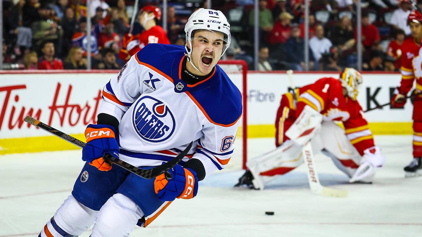 Sep 21, 2025; Calgary, Alberta, CAN; Edmonton Oilers center Connor Clattenburg (64) celebrates his goal against Calgary Flames goaltender Devin Cooley (1) during the third period at Scotiabank Saddledome. Mandatory Credit: Sergei Belski-Imagn Images