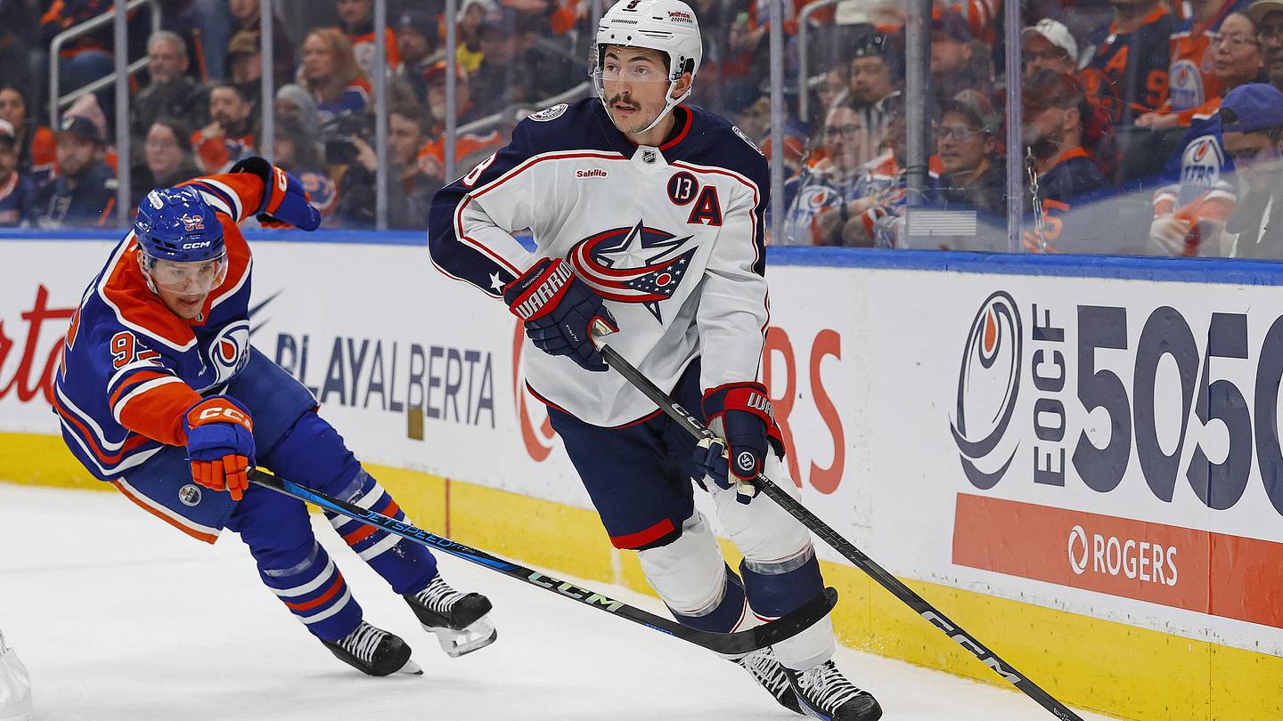 Nov 23, 2024; Edmonton, Alberta, CAN; Columbus Blue Jackets defensemen Zach Werenski (8) makes a pass in front of Edmonton Oilers forward Vasily Podkolzin (92) during the first period at Rogers Place. Mandatory Credit: Perry Nelson-Imagn Images