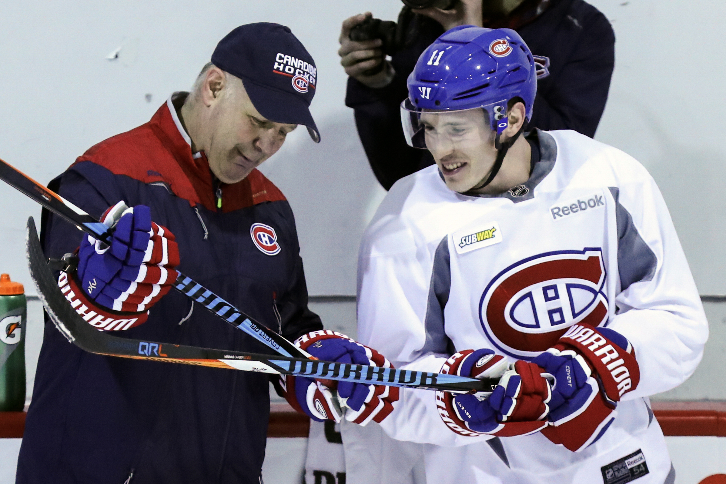 Claude Julien compares hockey sticks with Brendan Gallagher