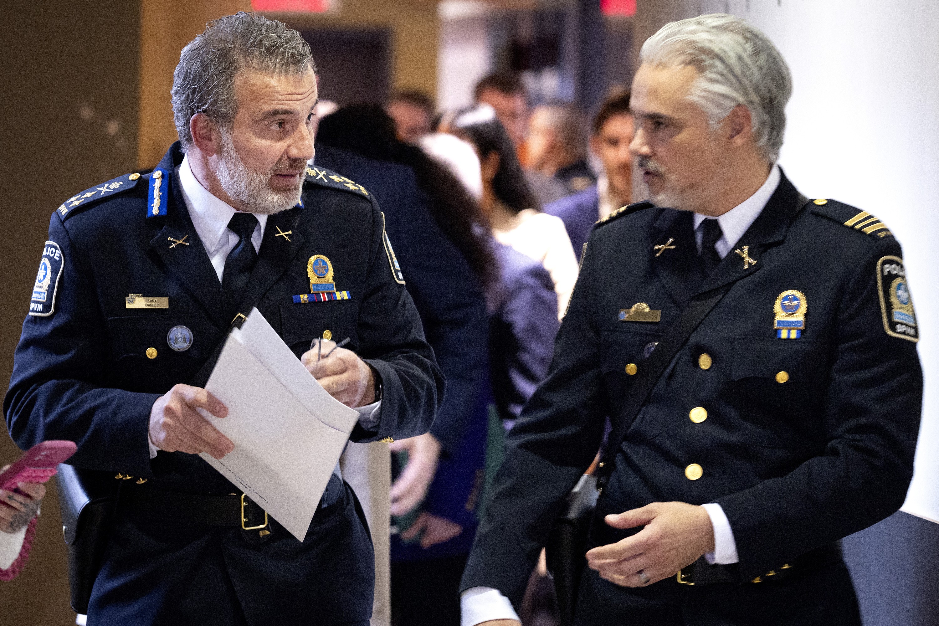 Montreal police chief Fady Dagher, left, speaks with François Sauvé as they arrive to make an announcement at SPVM headquarters in Montreal, on Monday, March 30, 2026.