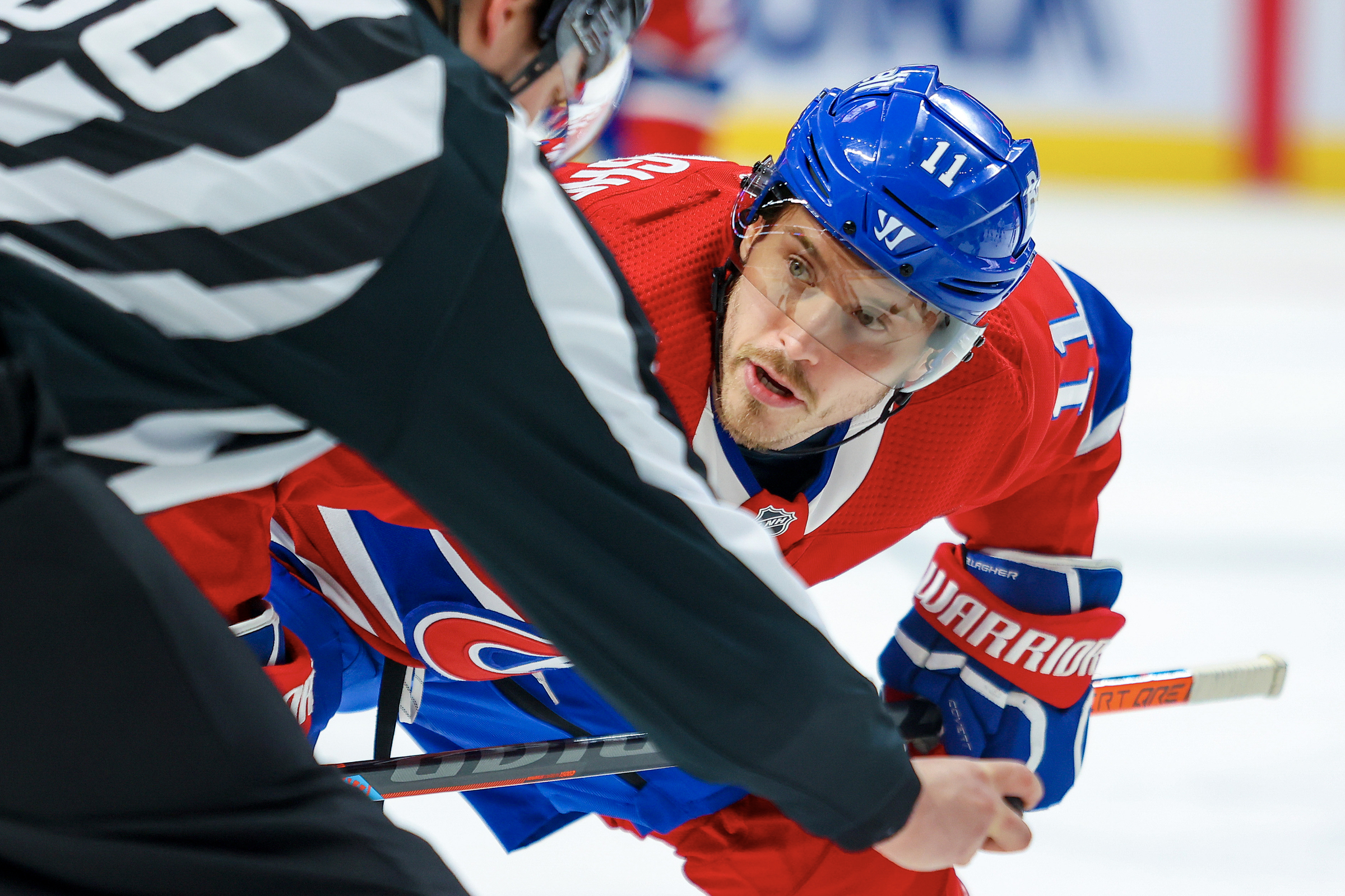Canadiens' Brendan Gallagher looks up at linesman Libor Suchanek while taking a faceoff 