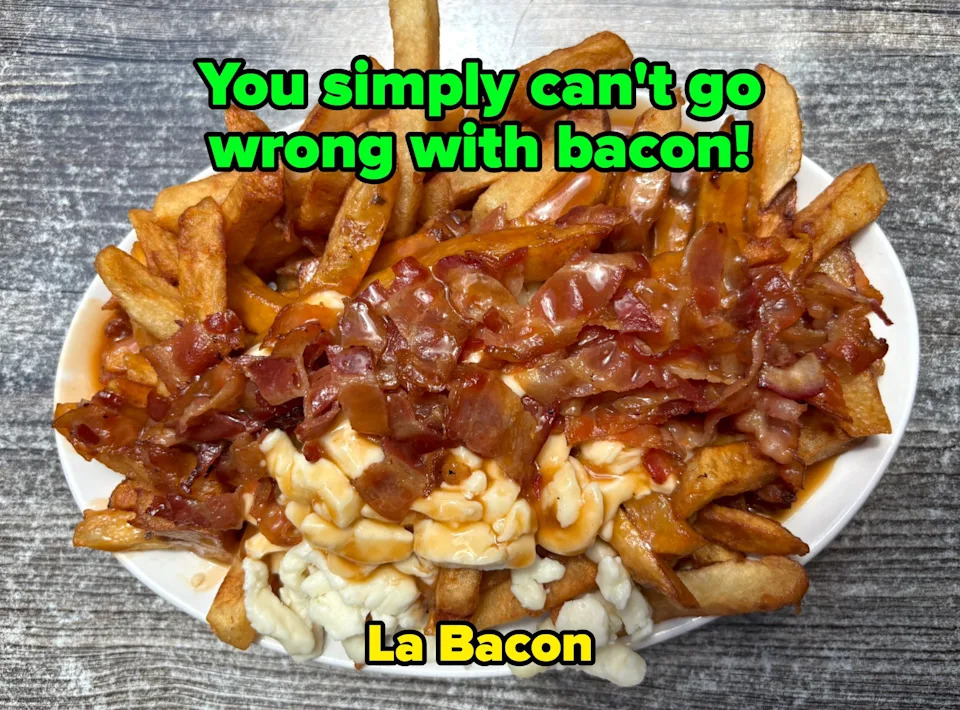A dish of fries topped with gravy, bacon, and cheese curds, resembling poutine, on a textured table surface