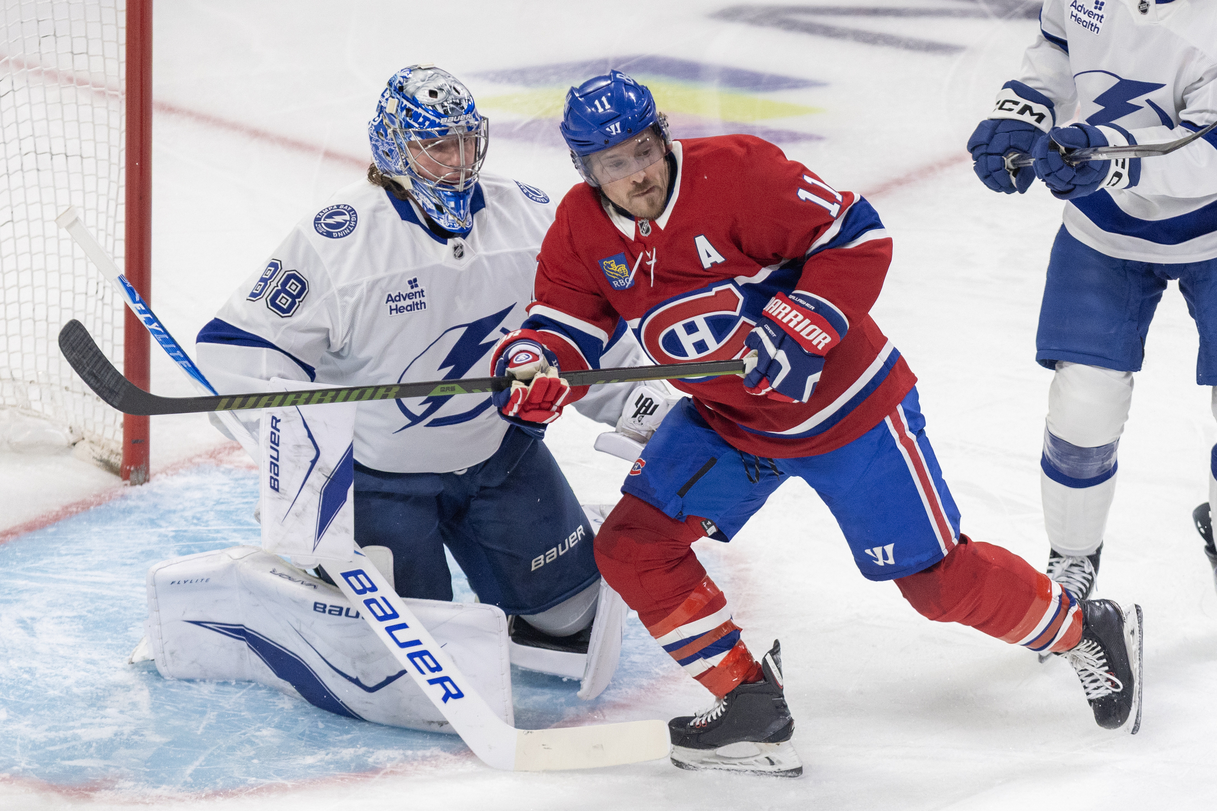 Brendan Gallagher between two Tampa Bay players.