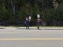 Protestors stand along Highway 7 in Kaladar during a series of rallies along the proposed northern route of the Alto high-speed rail project on Saturday, May 16, 2026 in Sharbot Lake, Ont.