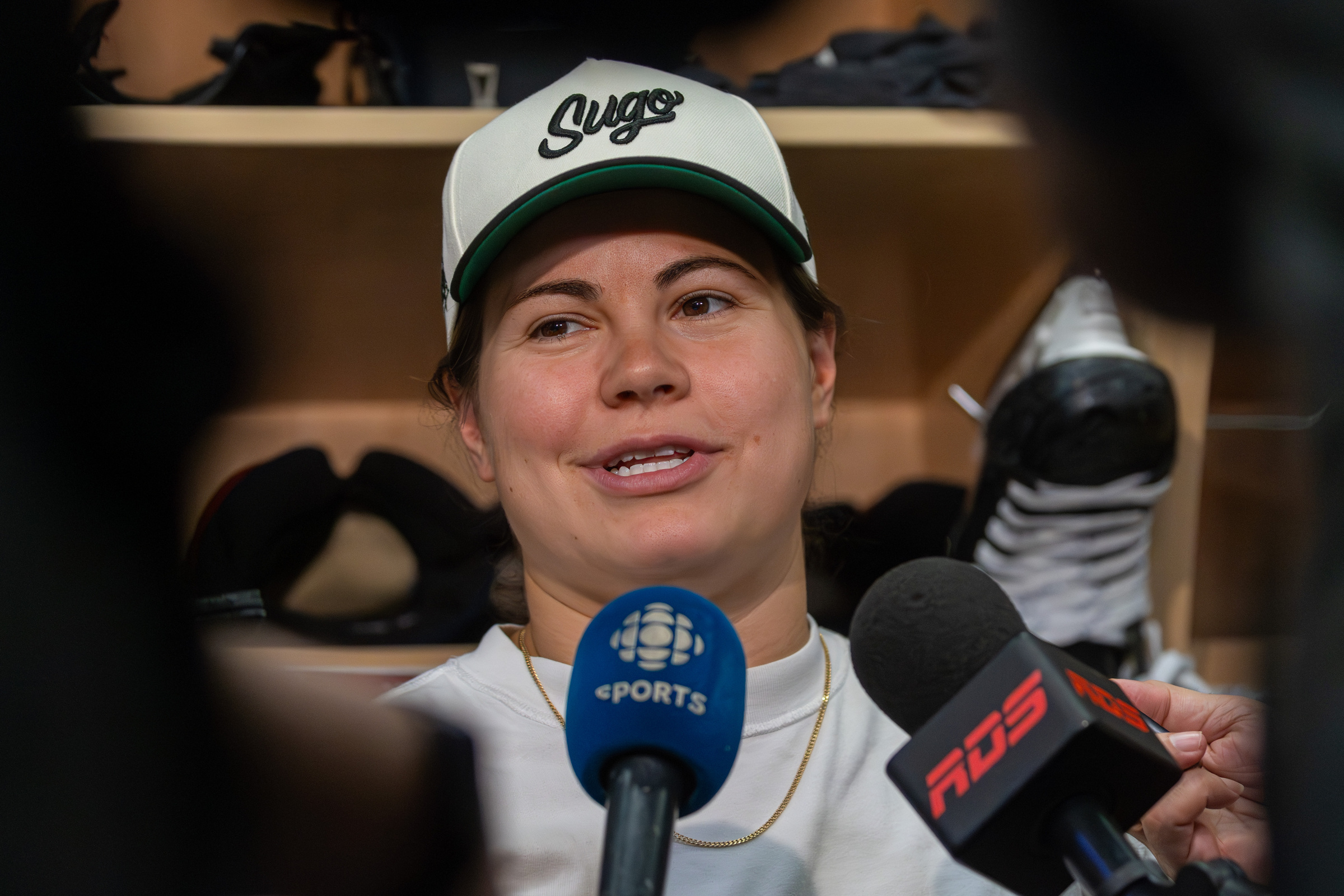 Abby Roque speaks to journalists in a dressing room.