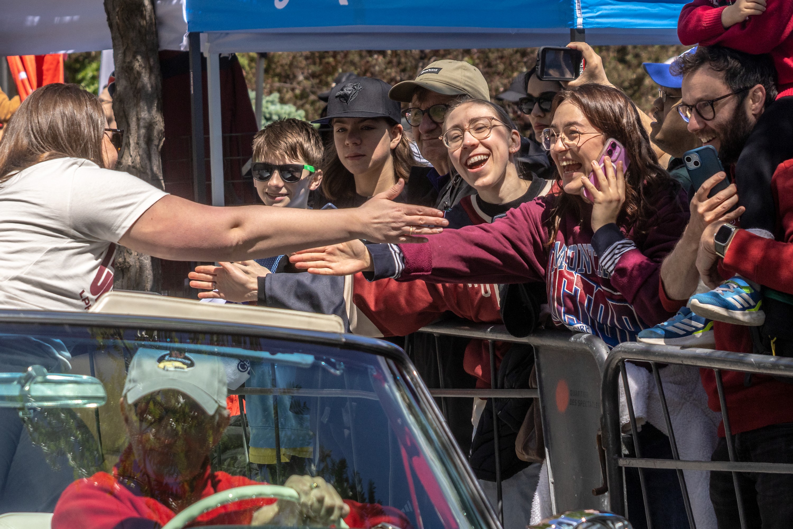 Montreal Victoire coach Kori Cheverie reaches out to fans during a victory parade.