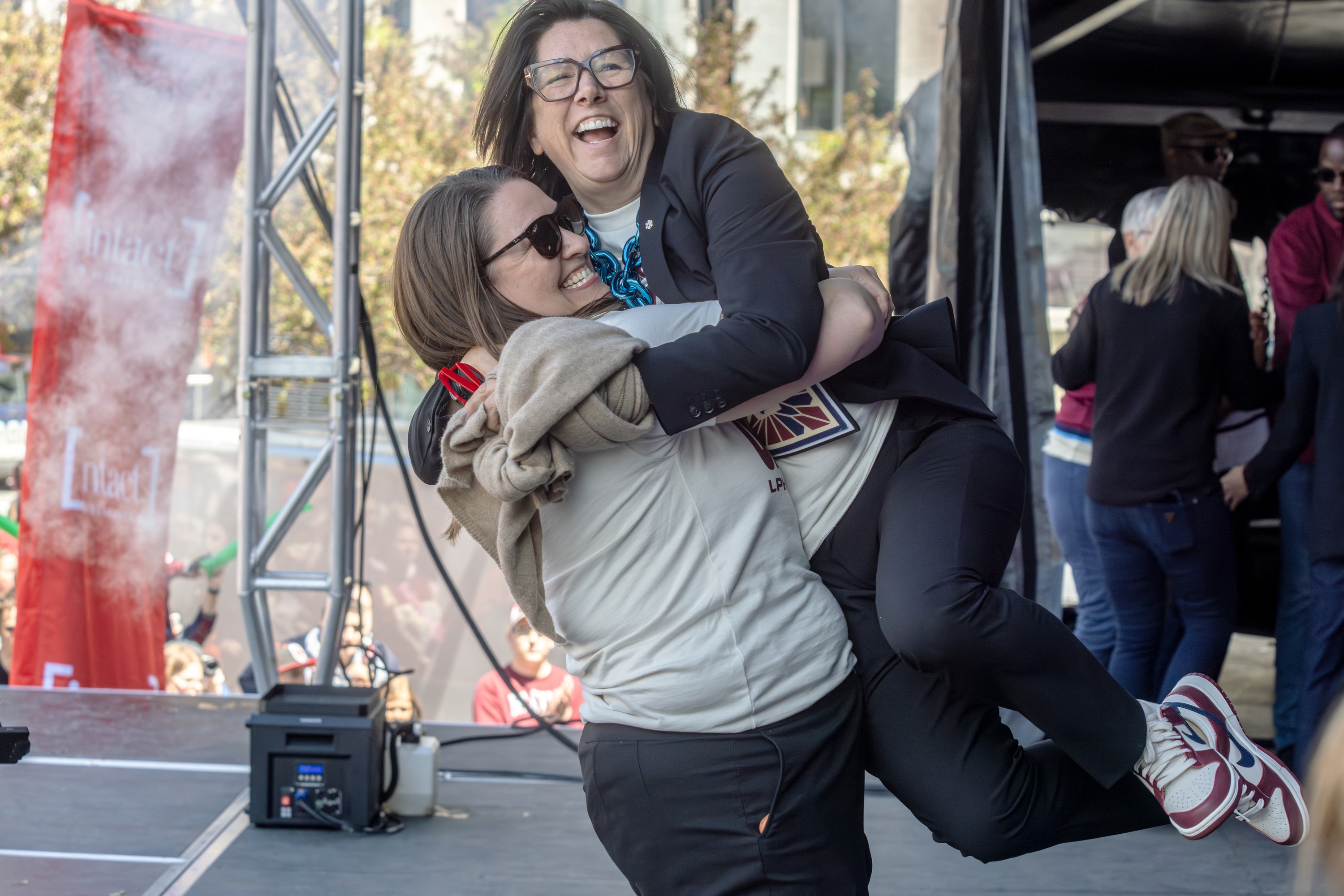 Montreal Victoire team general manager Danièle Sauvageau is lifted up on stage by coach Kori Cheverie during the team's celebrations.  