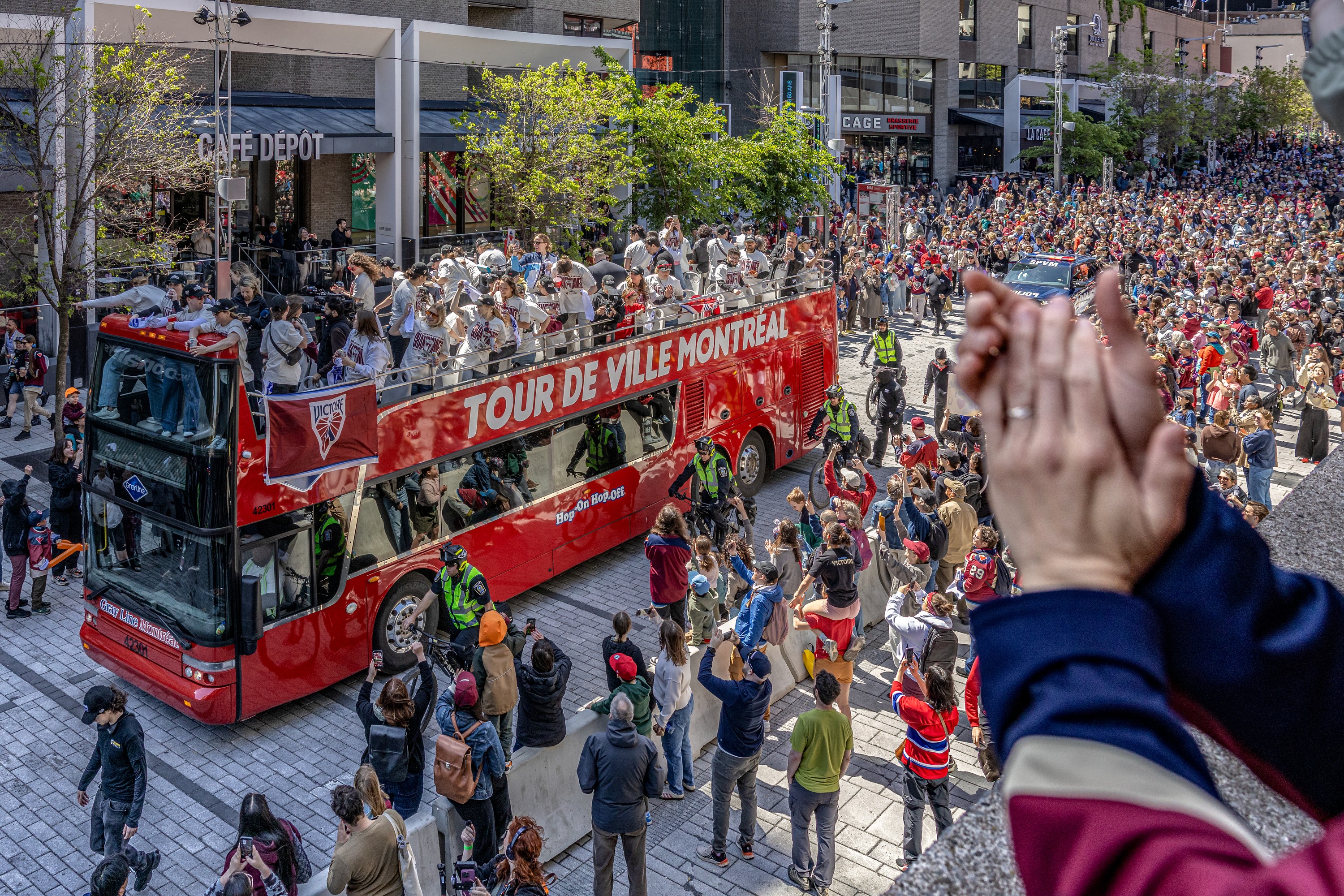The Montreal Victoire celebrate their PWHL championship on top of a double-decker bus.