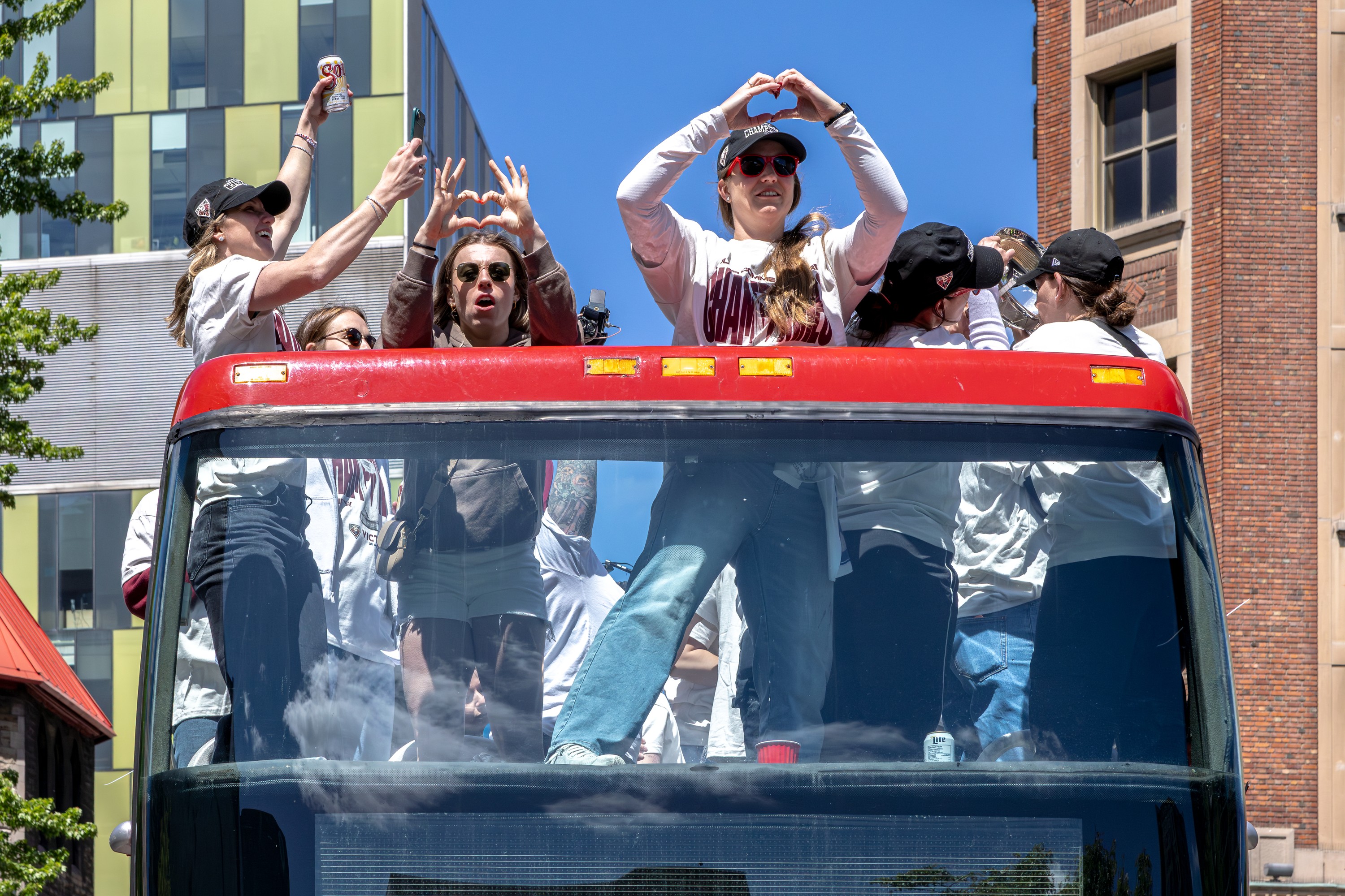 The Montreal Victoire, on a double-decker bus, celebrate their PWHL championship.