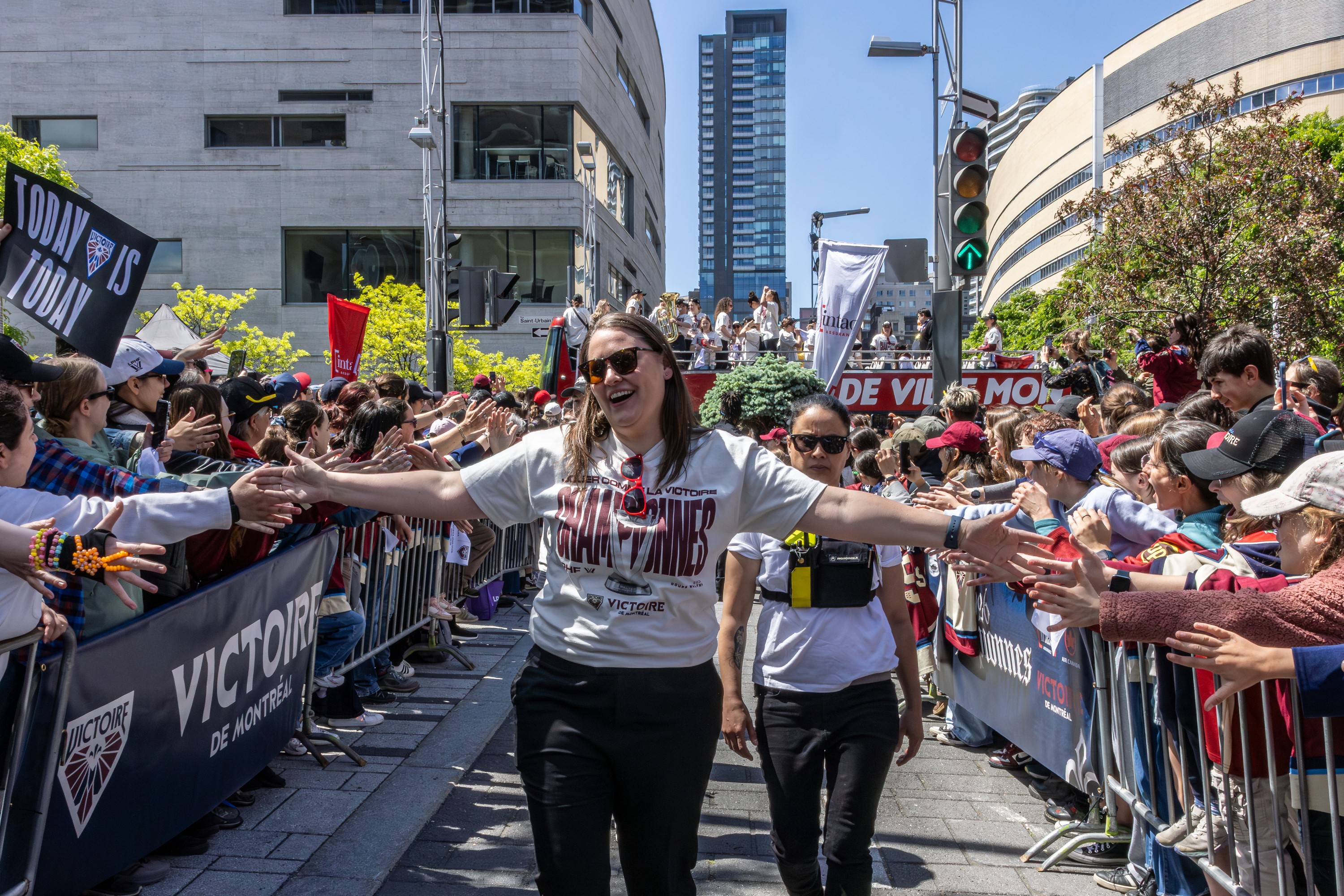 Montreal Victoire head coach Kori Cheverie makes her way past throngs of fans during the team's championship celebration.