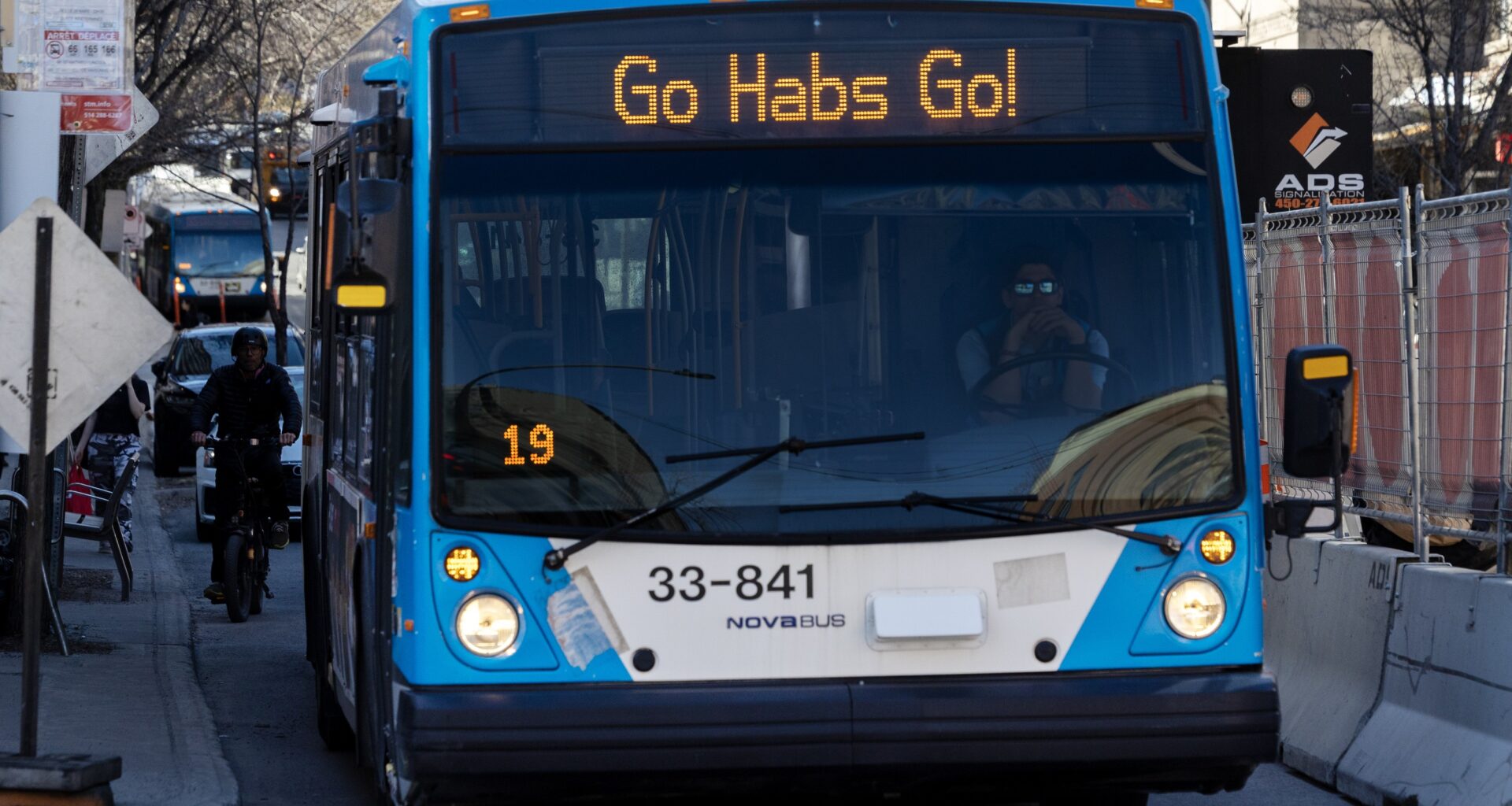 A bus displays the phrase Go Habs Go as it waits at a stop.