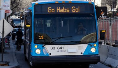 A bus displays the phrase Go Habs Go as it waits at a stop.