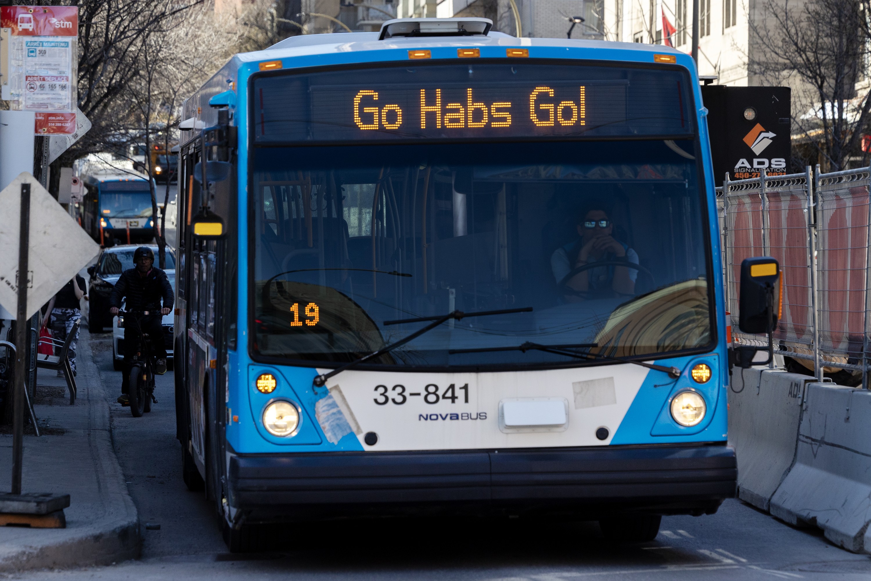 A bus displays the phrase Go Habs Go as it waits at a stop.