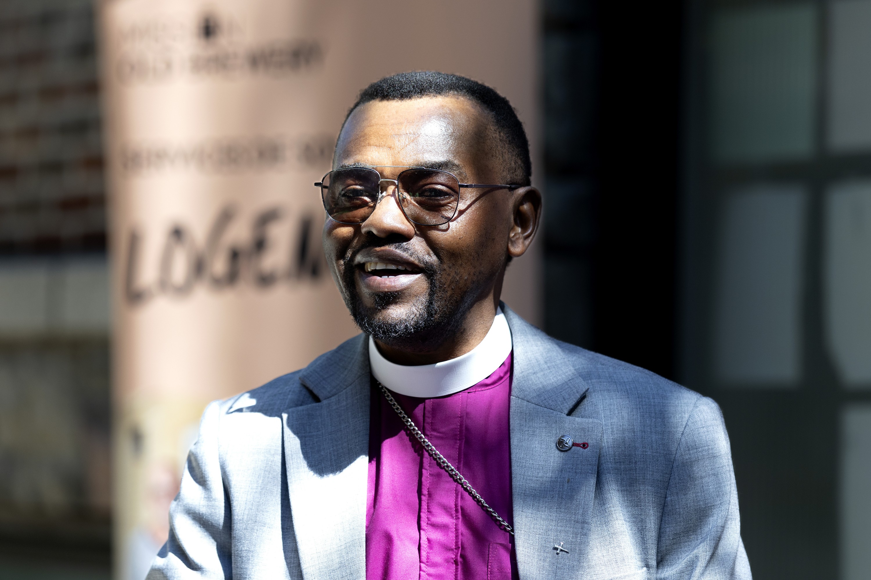 Profile of a bishop in a white collar.