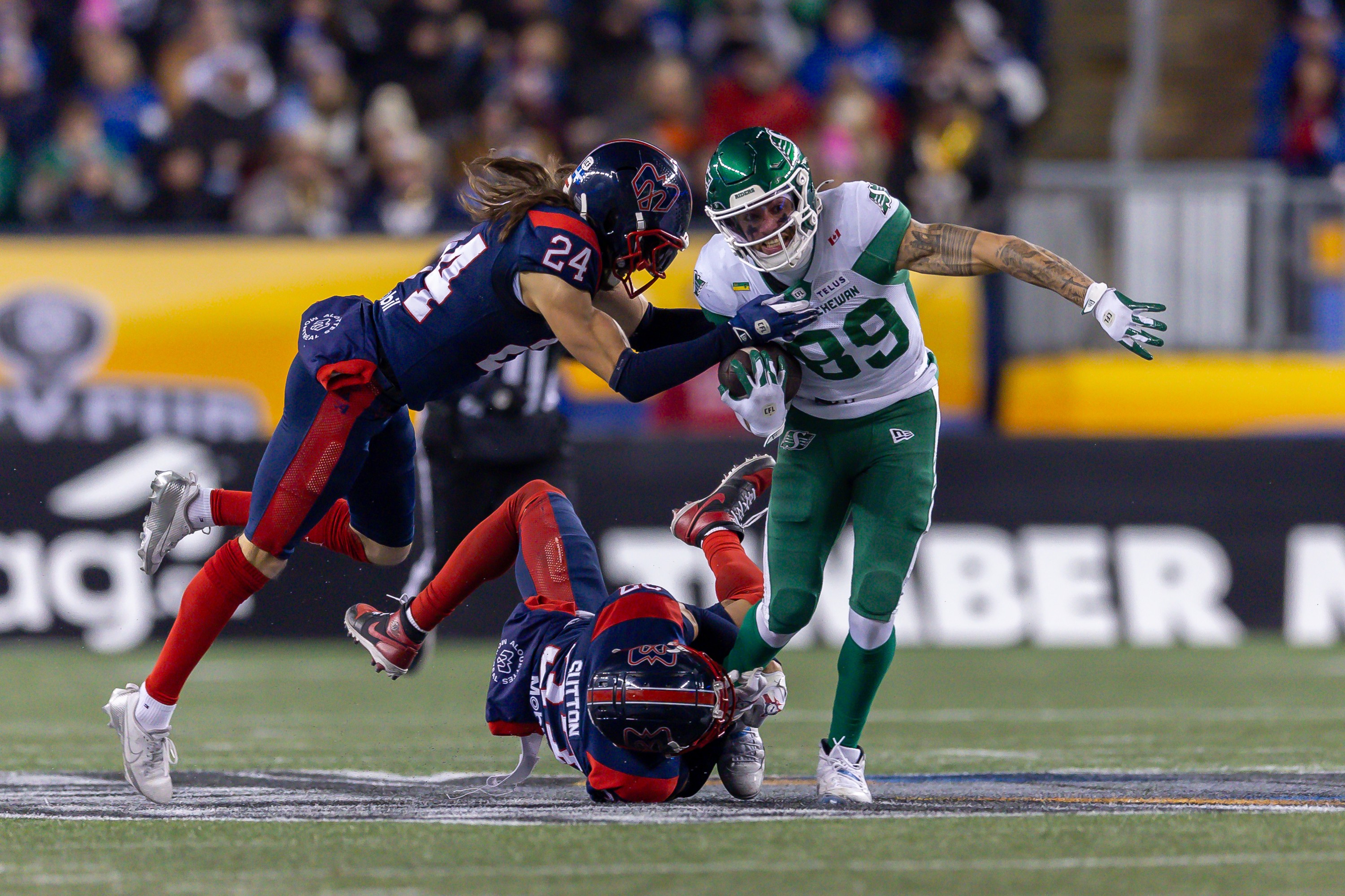 Alouettes safety Marc-Antoine Dequoy, left, and defensive-back Wesley Sutton bring down Saskatchewan Roughriders wide-receiver Kian Schaffer-Baker during Grey Cup in Winnipeg on Nov. 16.