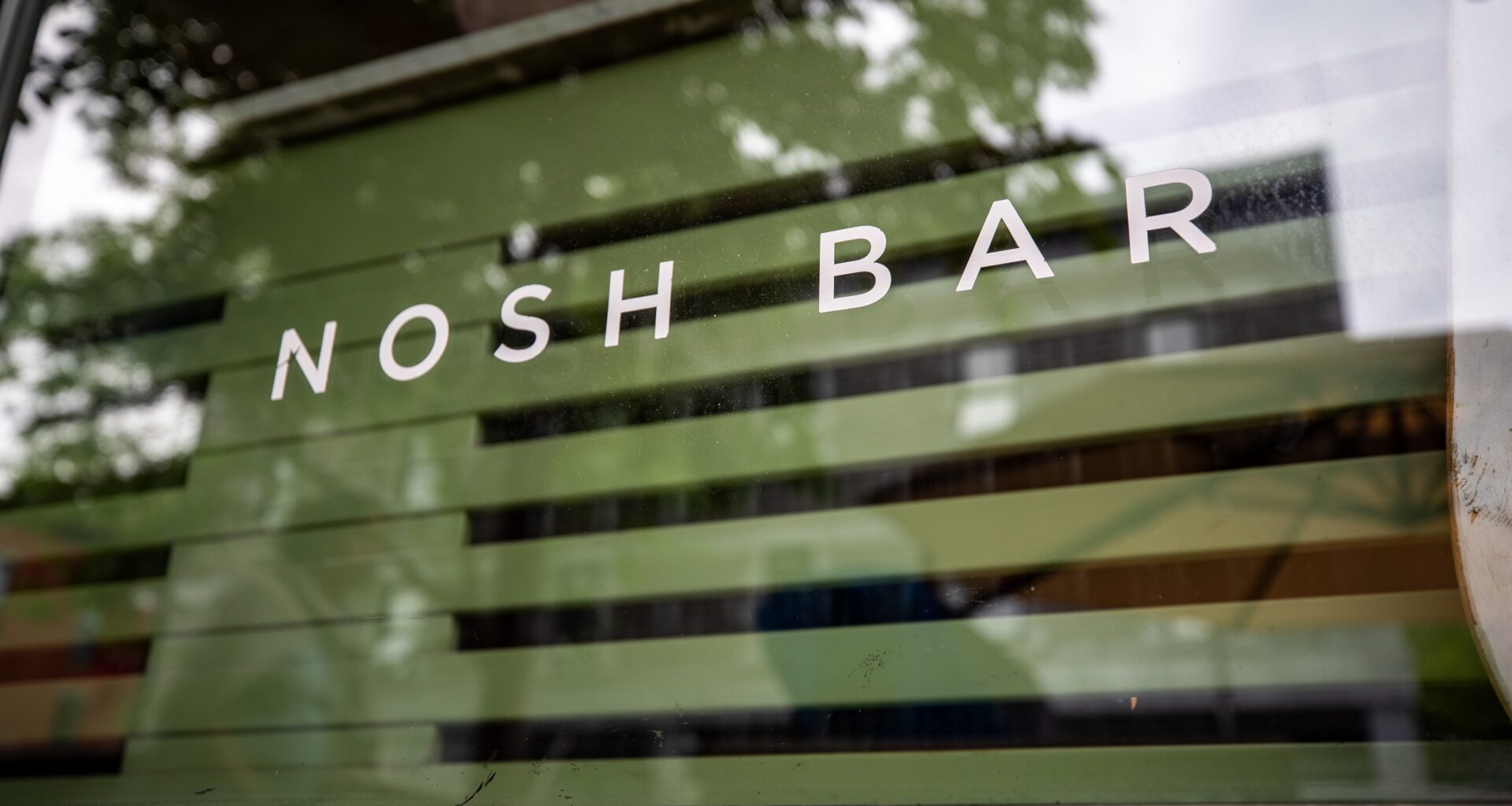 Close-up of restaurant signage reading: Nosh Bar