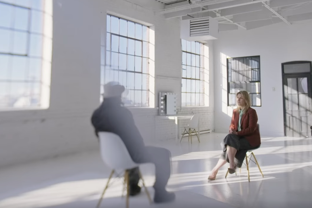 David, seated, with his back to the camera, talks to interviewer Ingrid Falaise, right, in a scene from the documentary.
