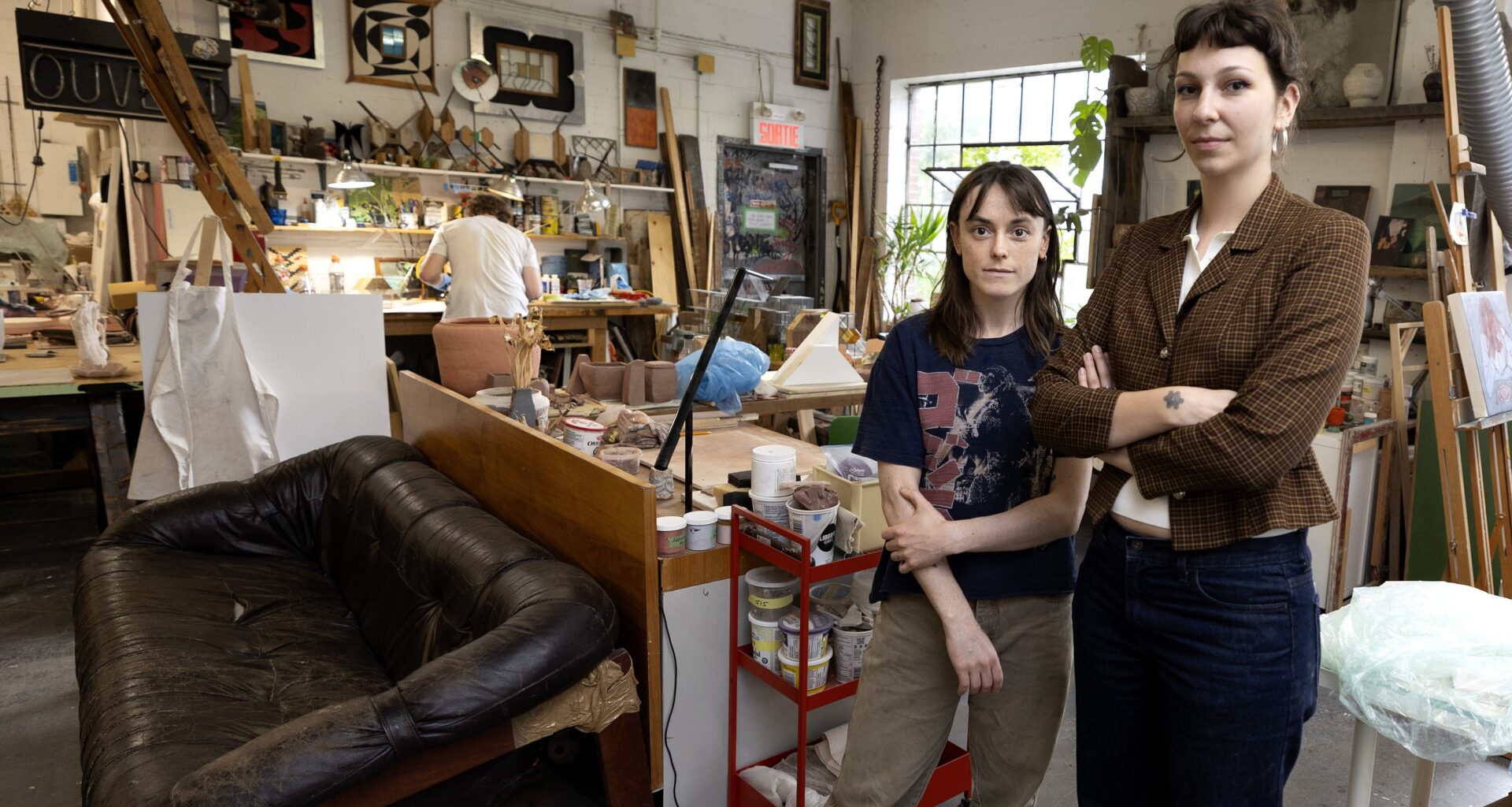 Two women stand in the artist loft.