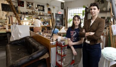 Two women stand in the artist loft.