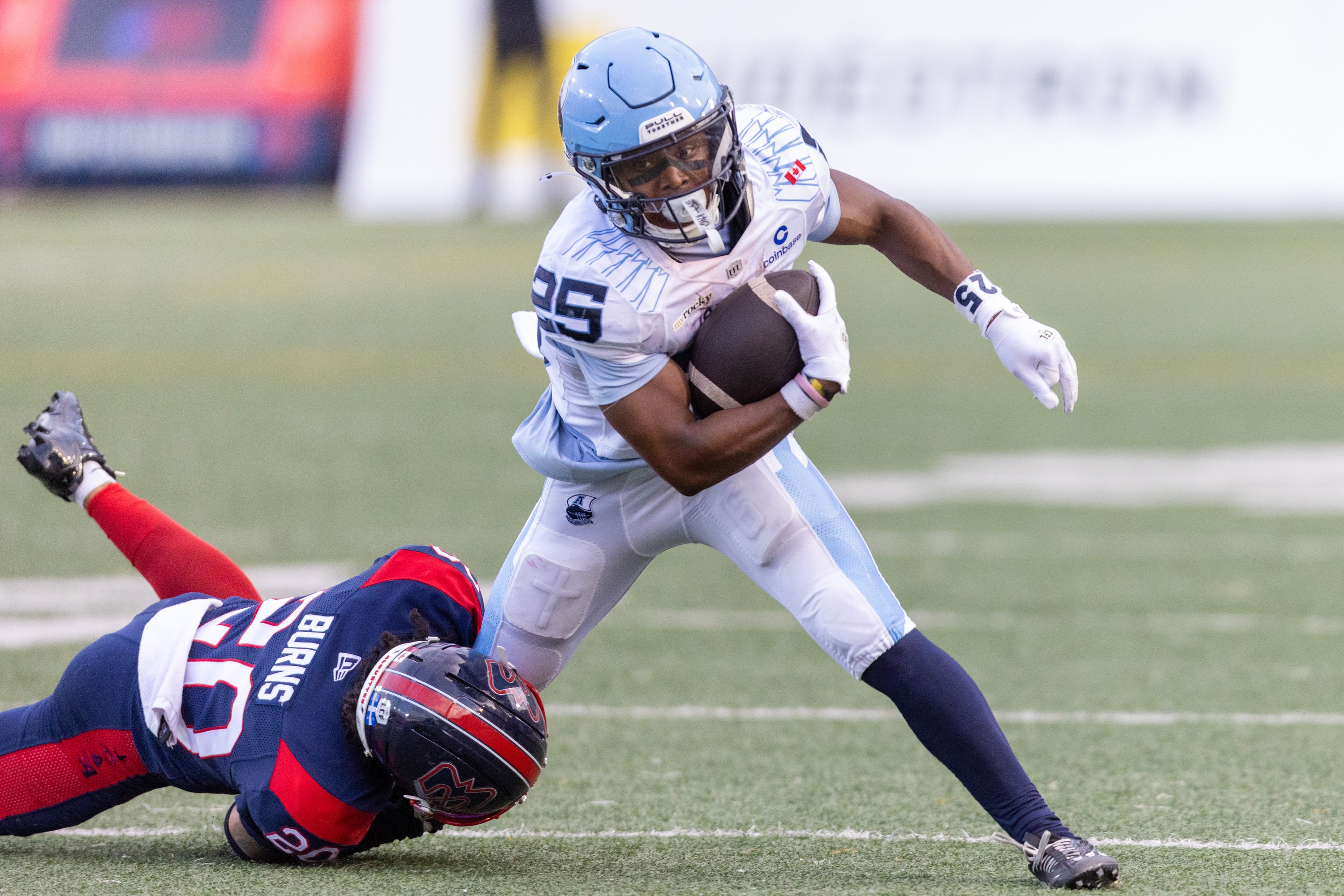Alouettes defensive-back Lorenzo Burns tackles Toronto Argonauts running-back Samuel Hicks during first half in Montreal on June 12.