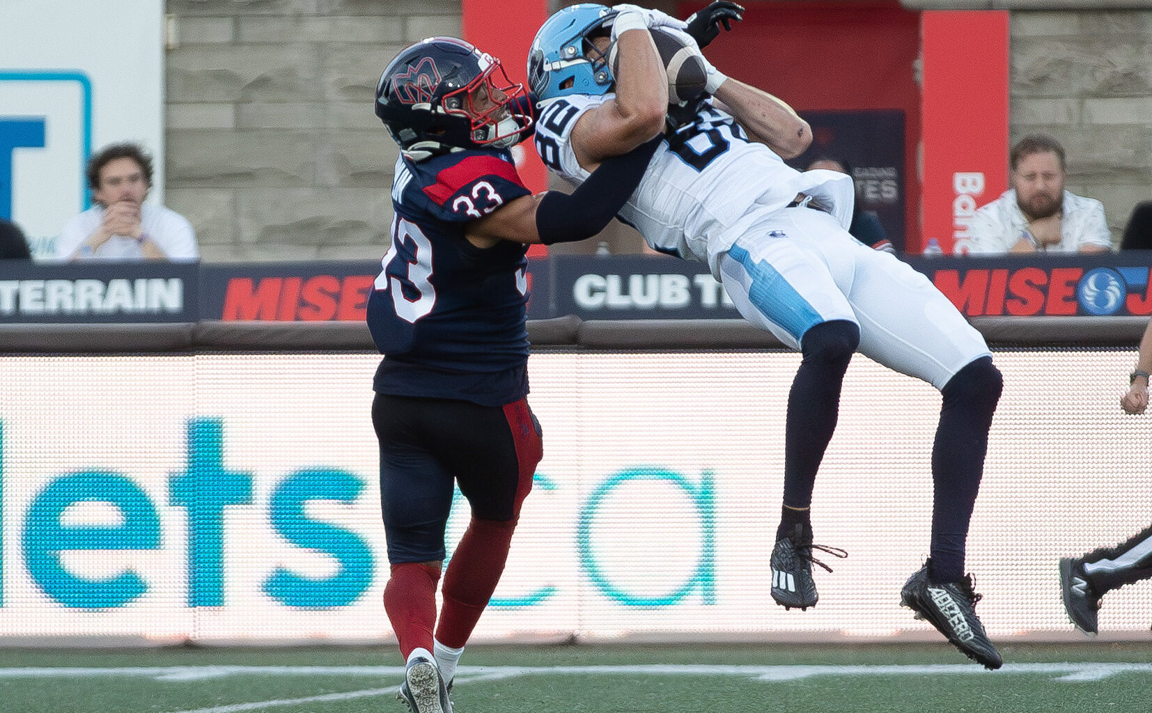 Alouettes defensive-back Arthur Hamlin brings down Toronto Argonauts receiver Tyler Kahmann during first half in Montreal on June 12.