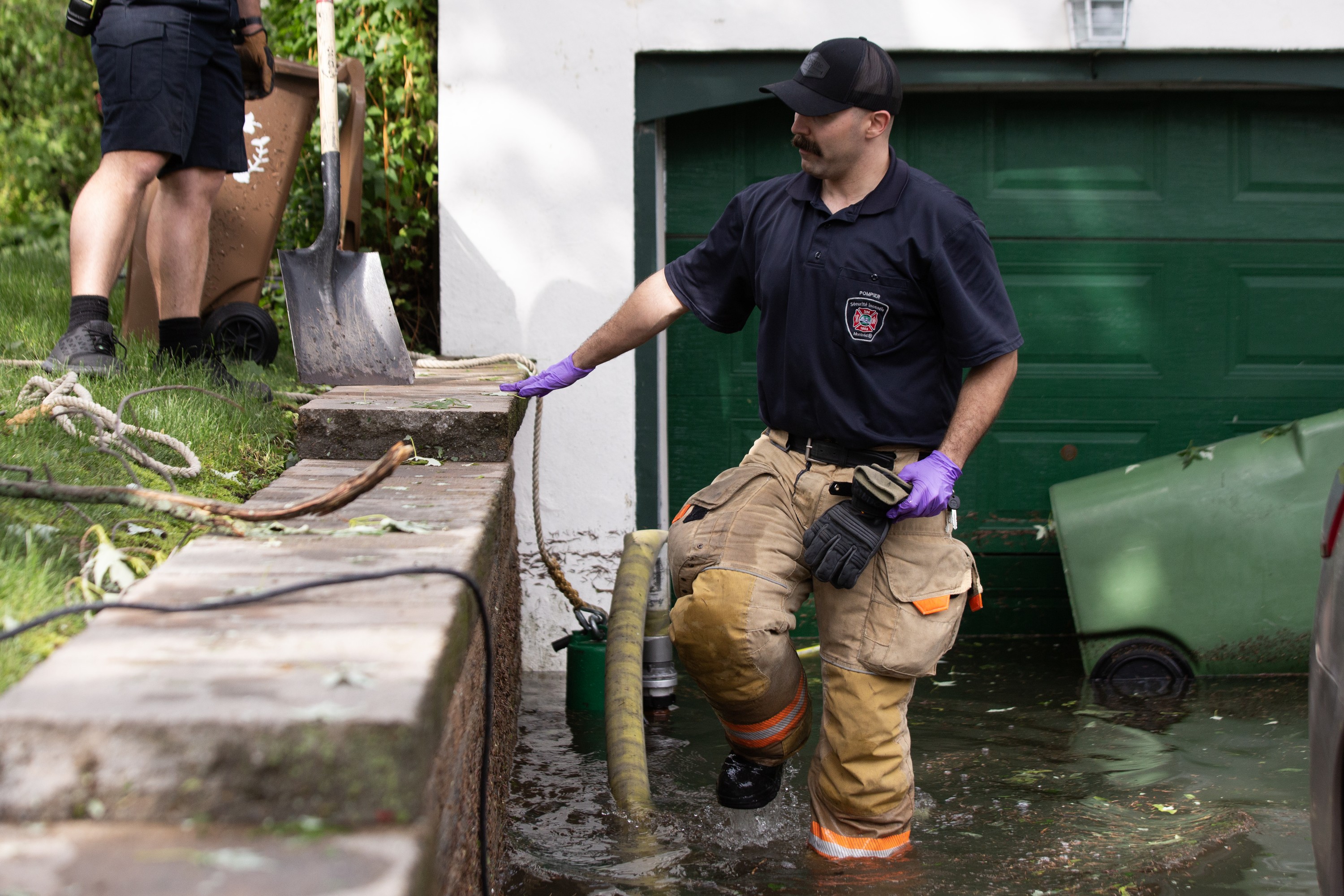A Montreal firefighter pumps water from a house.