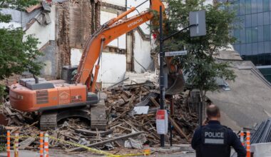 A Montreal police officer attends the scene of a building collapse on the corner of René-Lévesque Boulevard and Saint-Denis Street in Montreal on Tuesday, June 23, 2026.