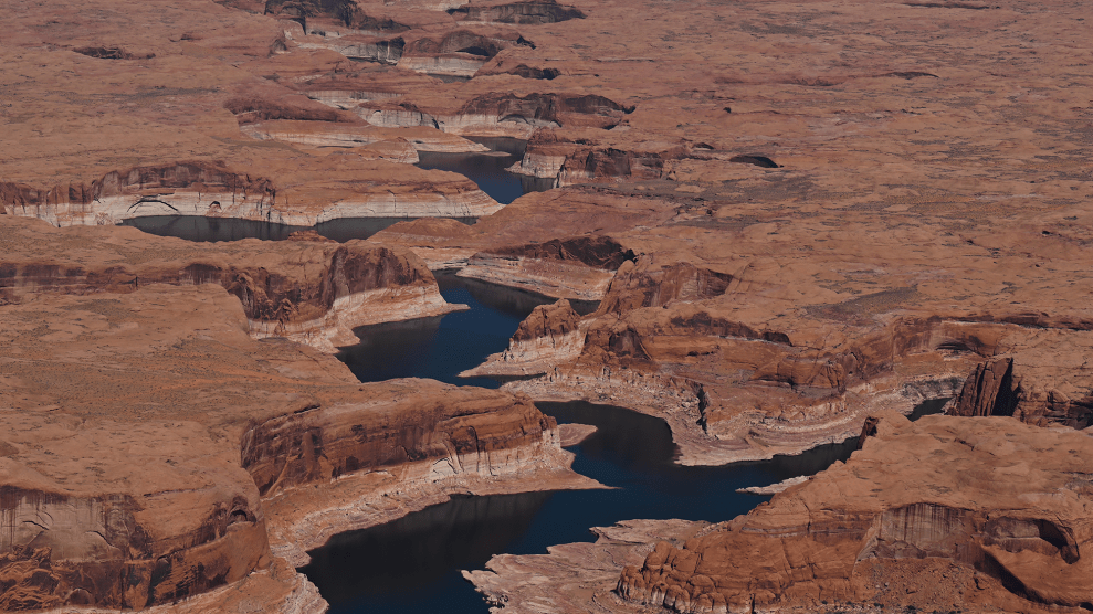A river winds between red rock.