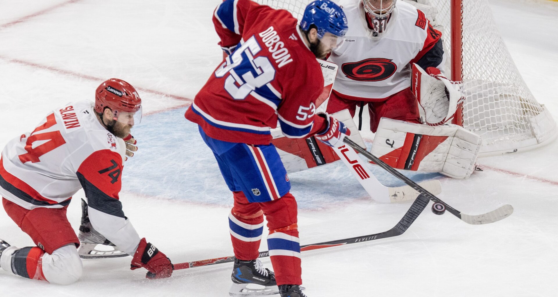 Canadiens defenceman Noah Dobson attempts to deflect a shot in front of Carolina Hurricanes goalie Frederik Andersen and Jaccob Slavin during Game 4 of Eastern Conference Final in Montreal on May 27.