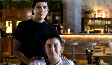 Diego Morales Cañizares and Maria Paula pose for a photo in a restaurant dining room.