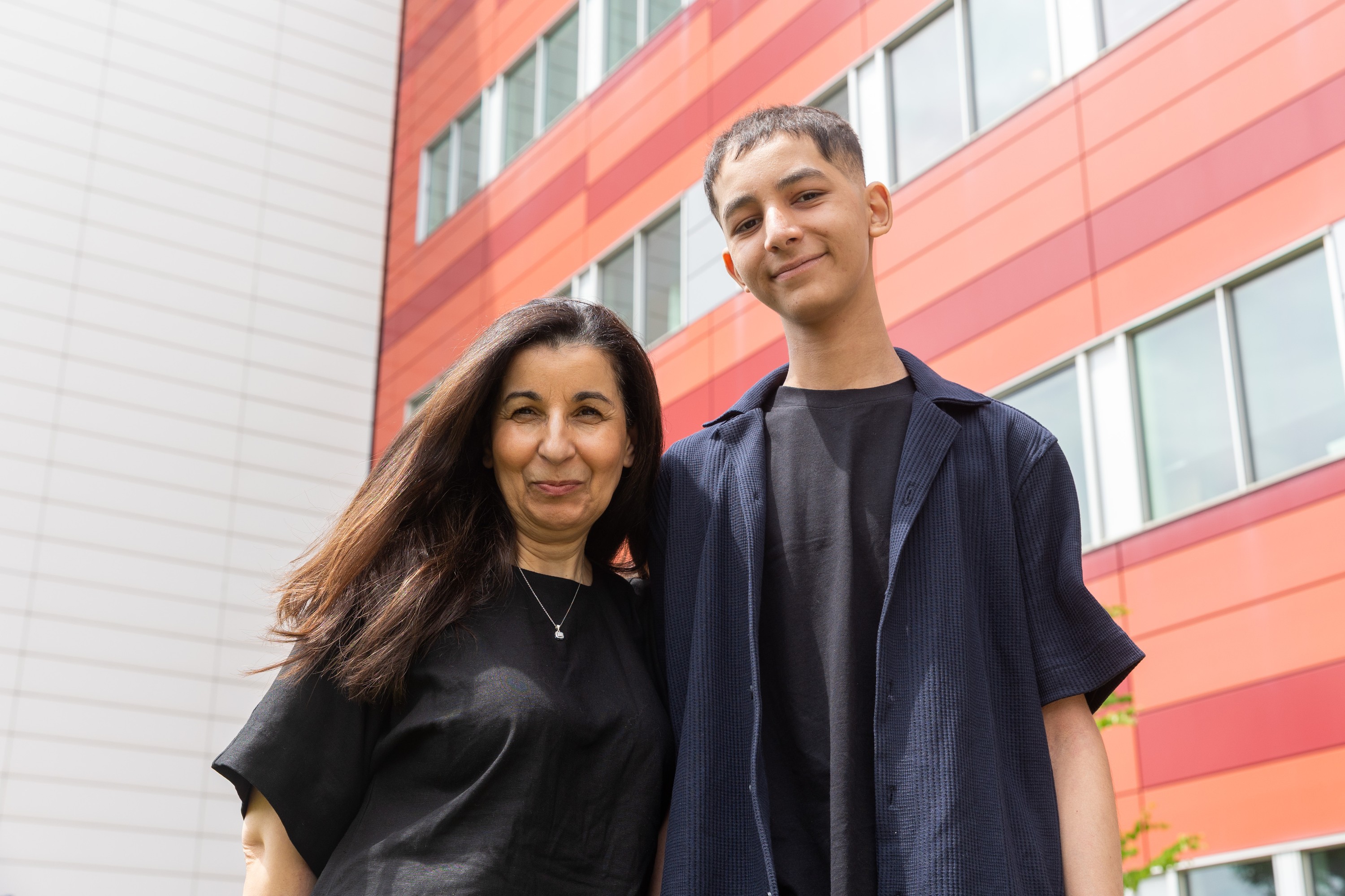 Sahmadia Bouhend, left, a hospital-based teacher who taught Adam math, stands close by him outside the Montreal Children's Hospital.