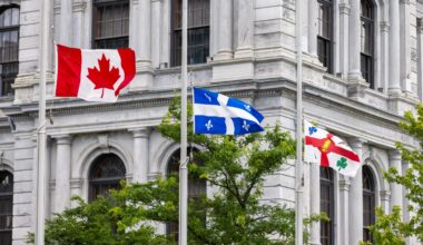 Canadian, Quebec and Montreal flags fly at half mast outside Montreal city hall